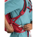 Osprey Raptor 14 backpack. Model showing the stash side pocket.