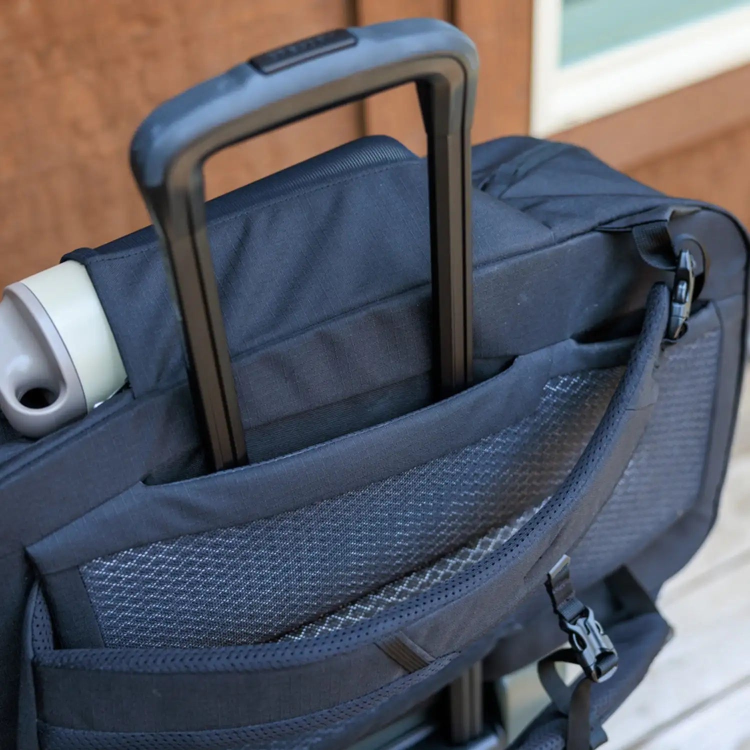 Gregory Border Carry-On 40 in black, attached to roller bag