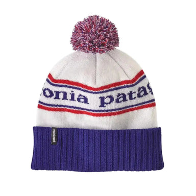 Patagonia beanie in white with a 3 inch blue cuff and Patagonia in blue with blue and red strips and a red, white, or blue pompom on top.