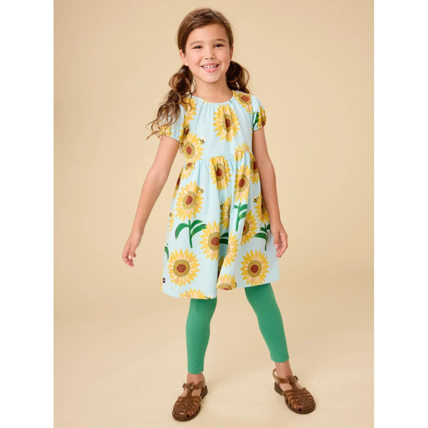 Tea Collection Girl's Puff Sleeve Empire Dress in painted sunflowers, model front view