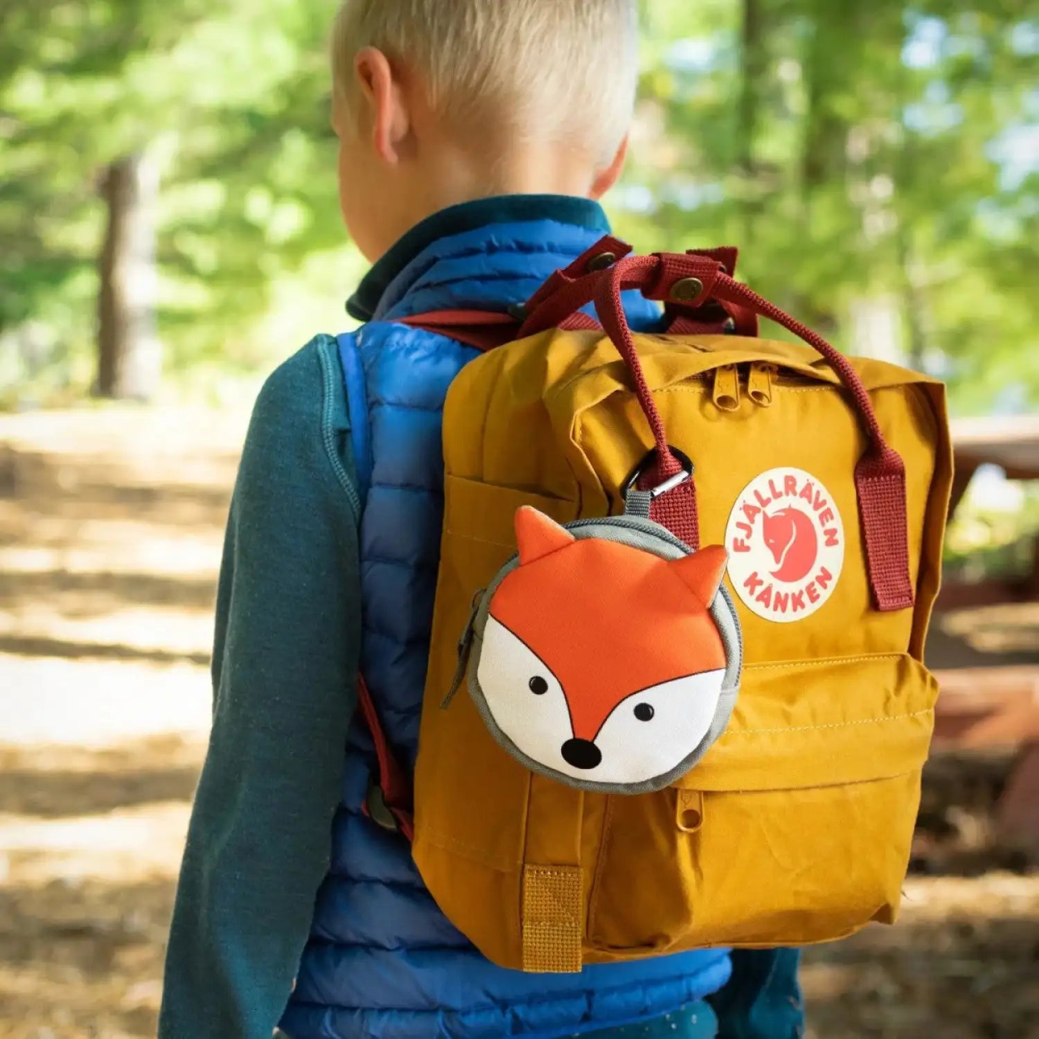Fox First Aid kit clipped to backpack bring carried by a young child.