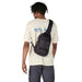 Patagonia Atom Sling Bag 8L in black, on model front view