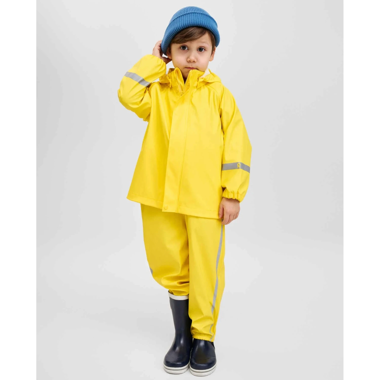 Reima Kid's Lampi Rubber Rain Jacket in yellow, model front view