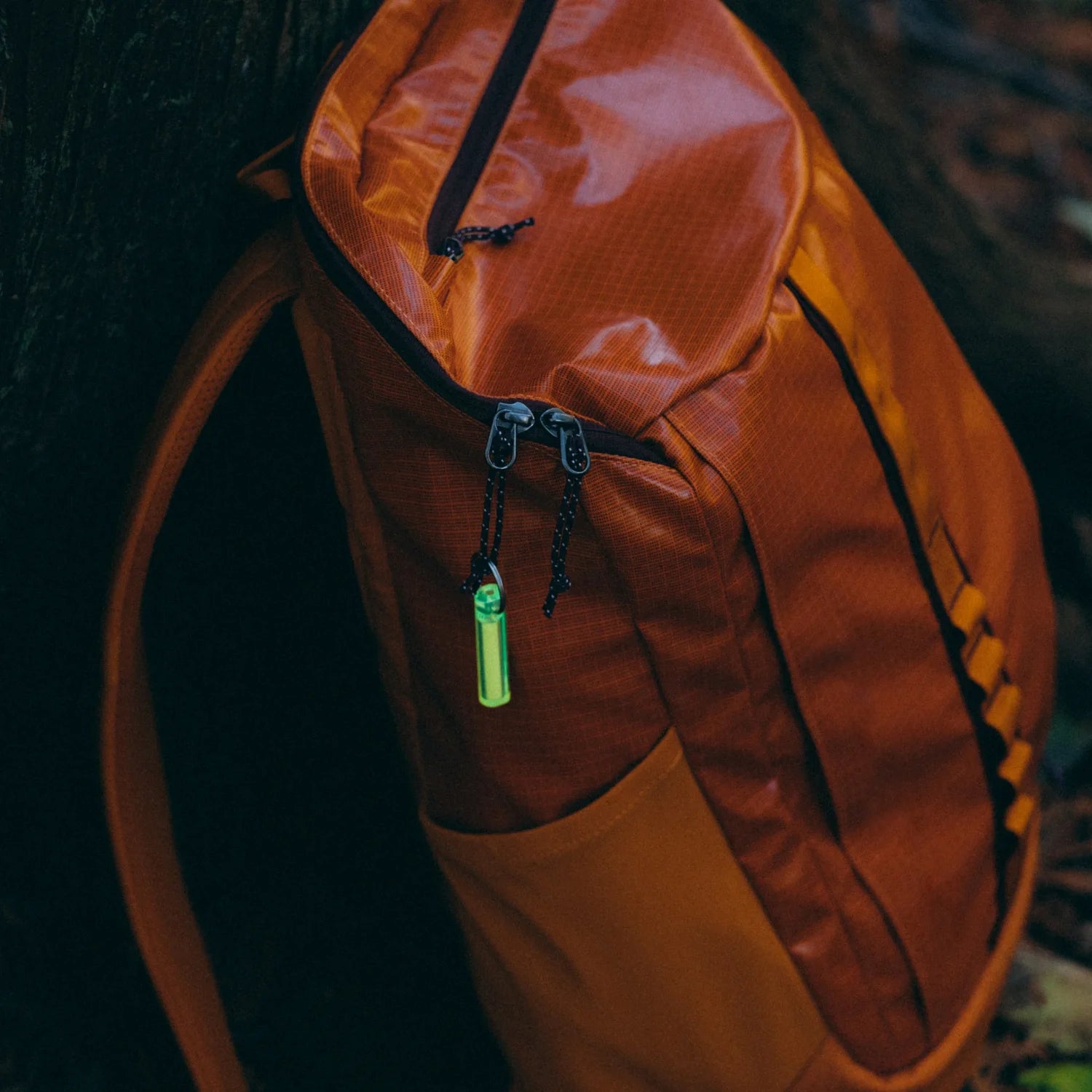 Gear Aid Ni Glo Gear Marker Keychain in green, attached to backpack zipper