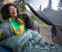 Therm-a-Rest Questar™ 20F/-6C Sleeping Bag size regular in balsam, on model in tent with dog at Bearcub Outfitters