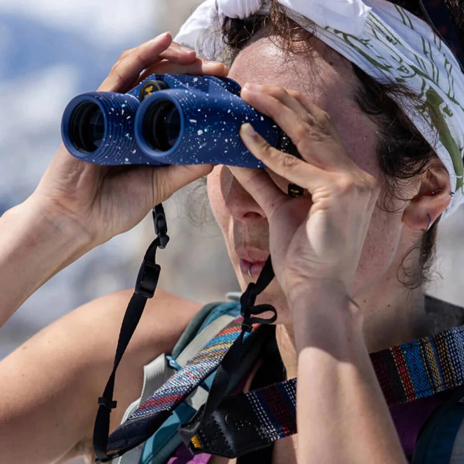 NOCS Standard Issue 10x25 Waterproof Binoculars in dusk glow blue, lifestyle view