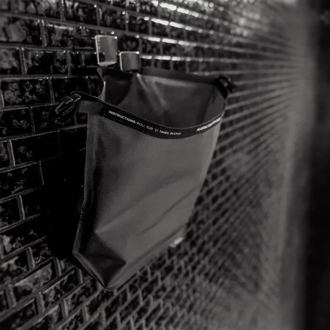Matador's toiletry case shown with hook being used in shower.