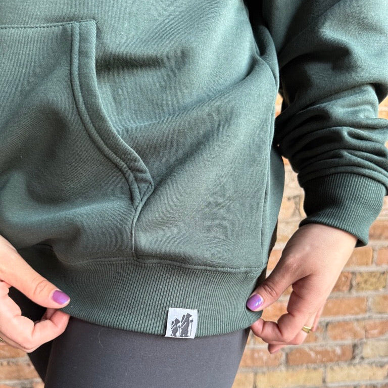 Bearcub Outfitters Unisex Logo Hoodie in Pine Grove, view of tag detail on model 