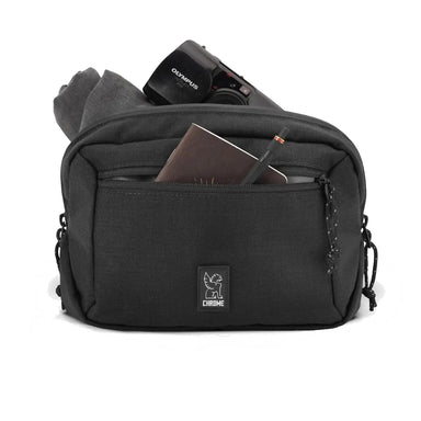 Chrome Industries Ziptop Waistpack shown in the black color option. Shown filled with items. 