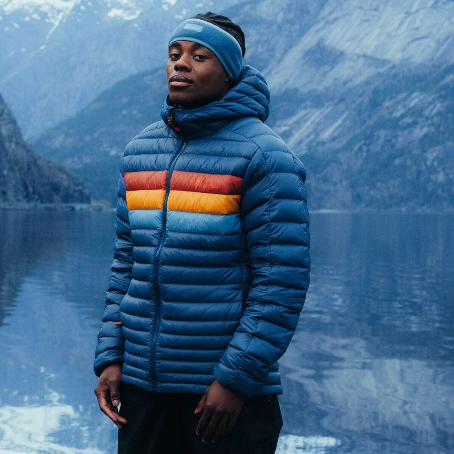 Cotopaxi Men's Fuego Hooded Down Jacket in deep sea stripes, on model lifestyle