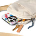 Cotopaxi Todo 1L Shoulder Bag in cream, packed open view