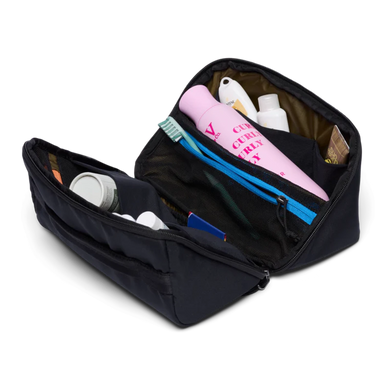 Black toiletry bag with various items on a white background
