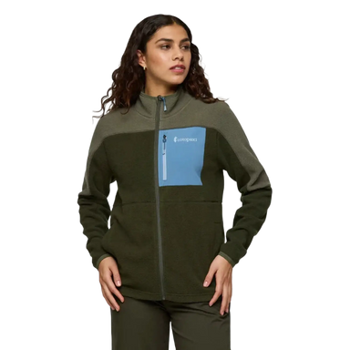 Woman wearing a green fleece jacket with a blue pocket on a white background