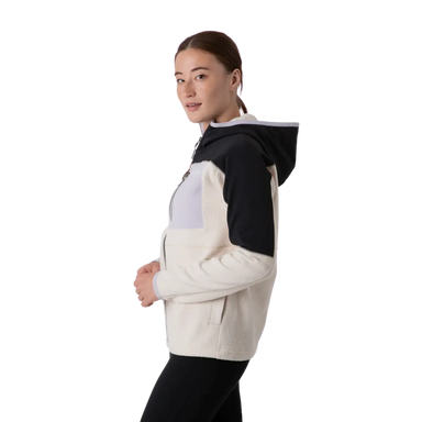 Cotopaxi Women's Abrazo Hooded Full Zip Jacket shown in the Black and Cream color option. Side view, on model.