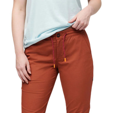 Cotopaxi Women's Salto Ripstop Pant shown in the Spice color option. Front view off waist and drawstring on model.