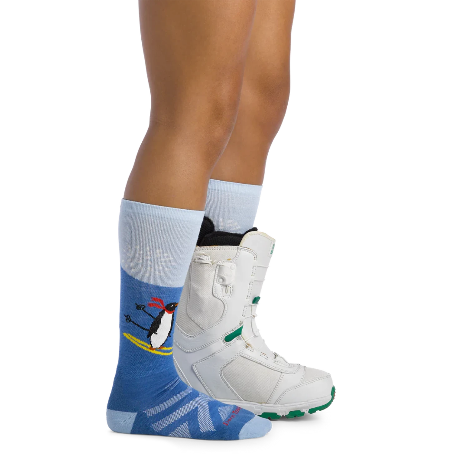 Darn Tough Kid's Penguin Peak Over-the-Calf Midweight Ski & Snowboard Sock shown on model.