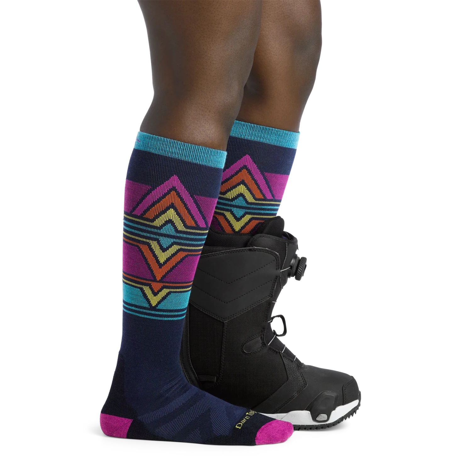 Darn Tough Women's Echo Over-the-Calf Midweight Ski & Snowboard Sock shown in the Eclipse color option on model.