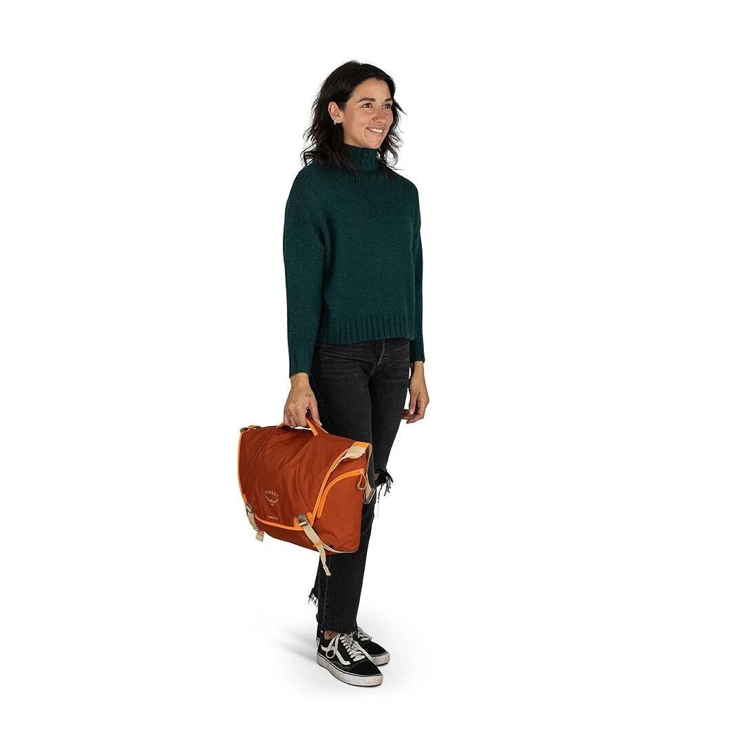 Osprey Daylite™ Messenger Bag in night shift, carried by top handle