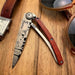 deejo 37g coral wood hunting day knife on a wood table detail view