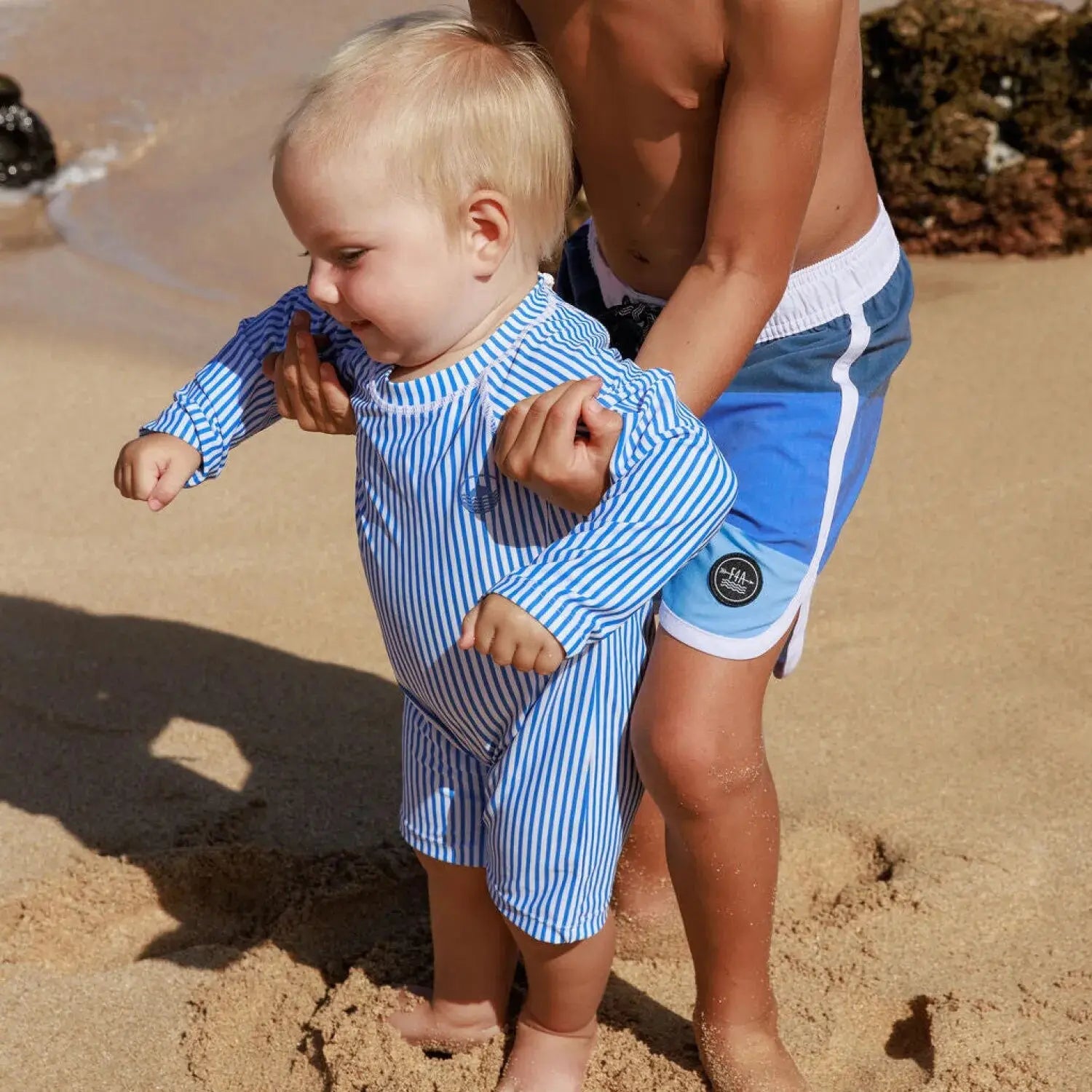 Feather 4 Arrow Baby Cali Rashguard Surf Suit in marina blue stripe, model lifestyle view