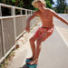 Feather 4 Arrow Boy's Volley Trunk in melon, front model view
