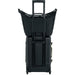 Fjall Raven Färden Crossbody in black, attached to roller suitcase