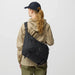 Fjall Raven Färden Crossbody in black, on model messenger bag