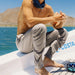 Free Fly Men's Breeze Pant in dark khaki, on model lifestyle view