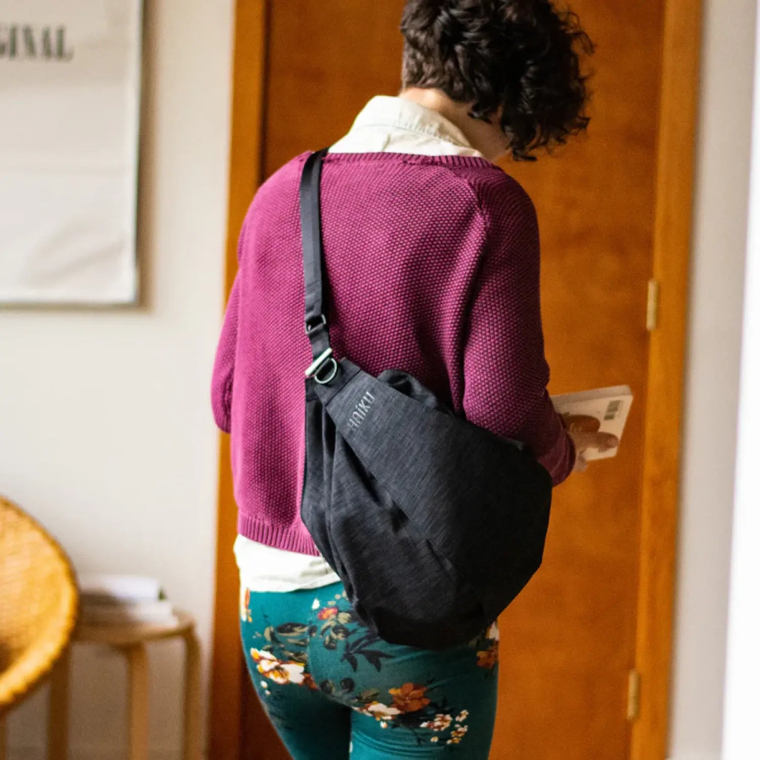 haiku crescent convertible sling bag in black in bloom model view