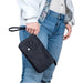 Haiku Stride Wristlet wallet clutch bag in black in bloom, held by model