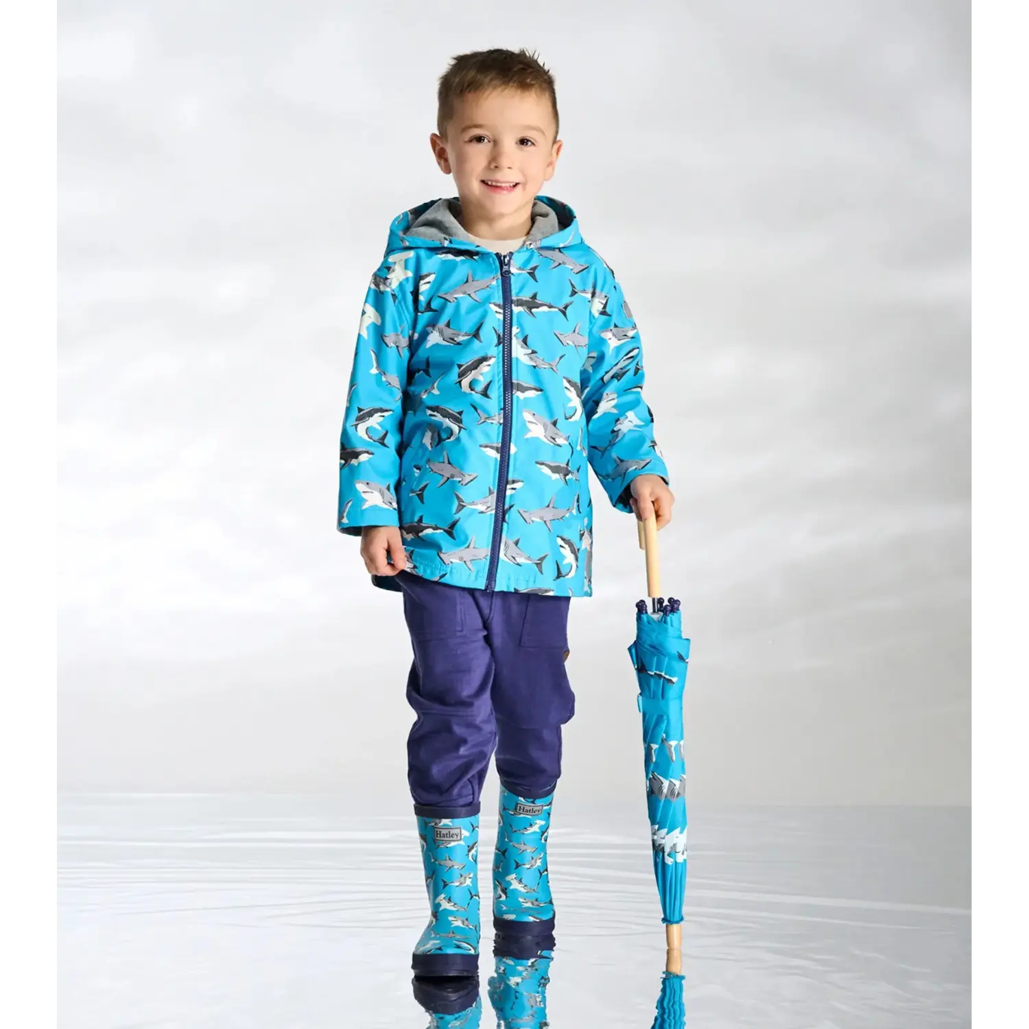 Hatley Kid's Colour Changing Zip-Up Rain Jacket in Shark Party, front view on model 