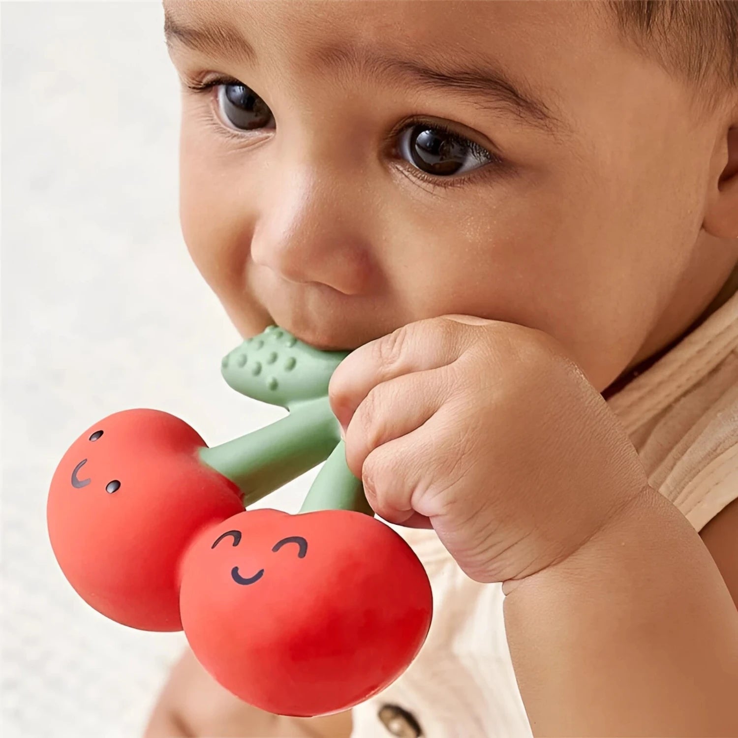 Itzy Ritzy Comfort Crew Teether in cherries, lifestyle view
