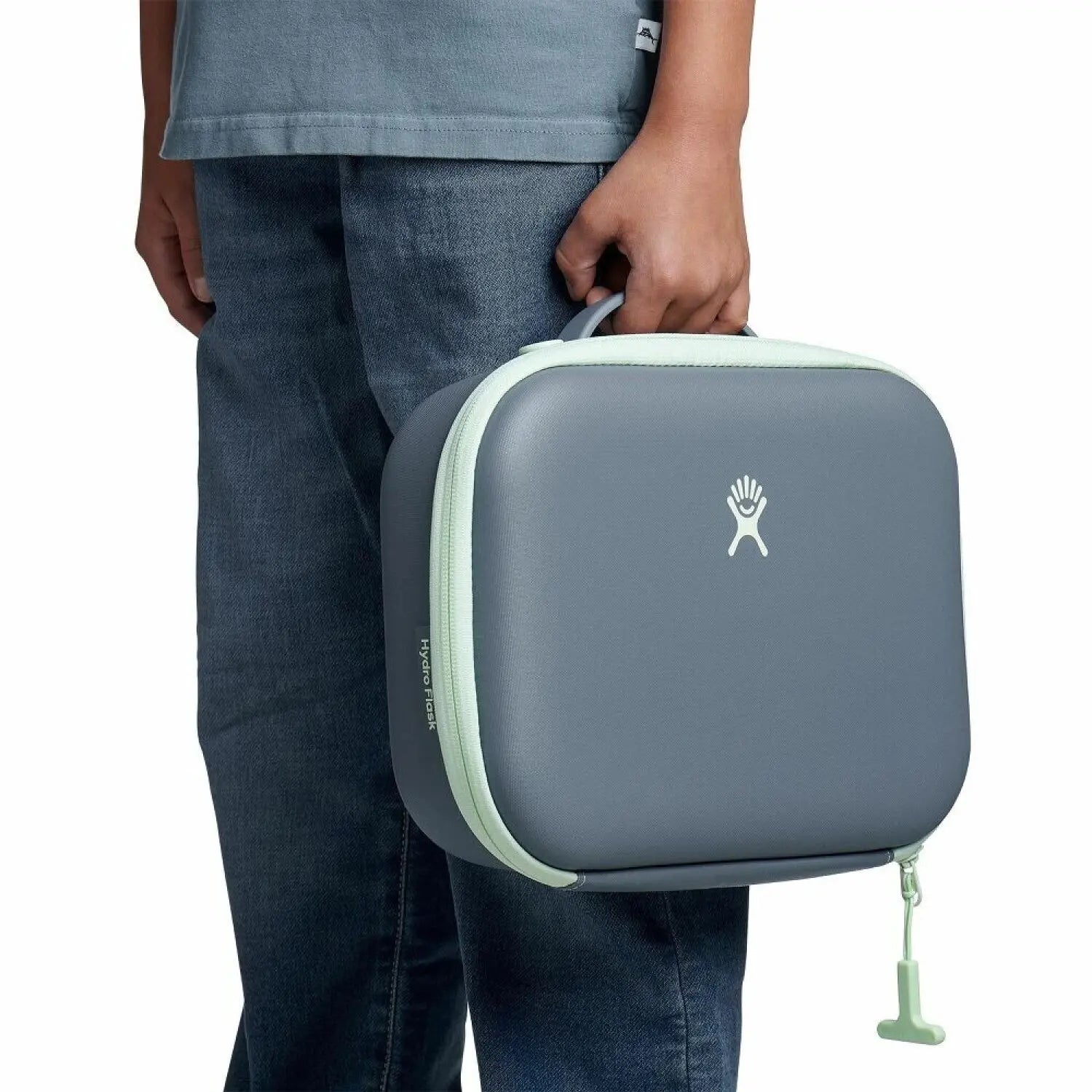 Hydroflask Kid's Lunch Box in koala, being held by model view