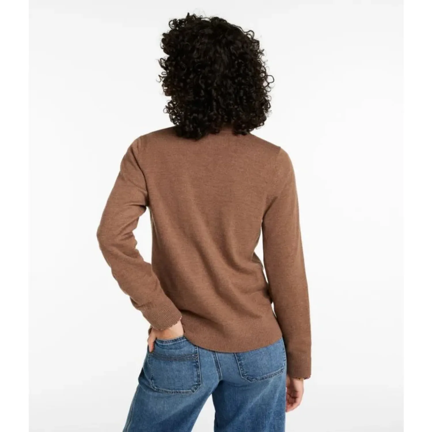 Person wearing a brown sweater and blue jeans on a white background