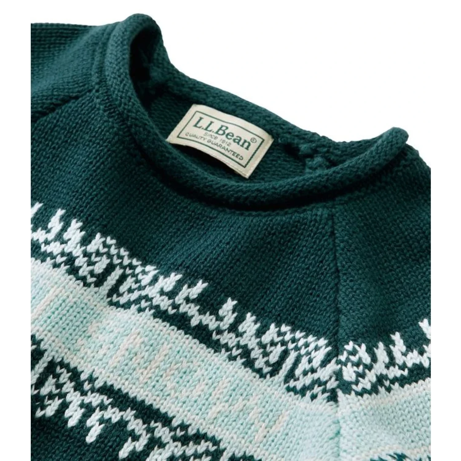 Close-up of a teal sweater with a patterned design and L.L.Bean label.