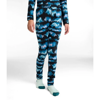 Person wearing a blue and black tie-dye outfit on a white background