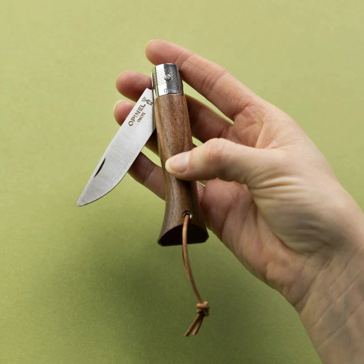 Opinel Néo6 Everyday Carry Folding Knife in black walnut, folded in hand