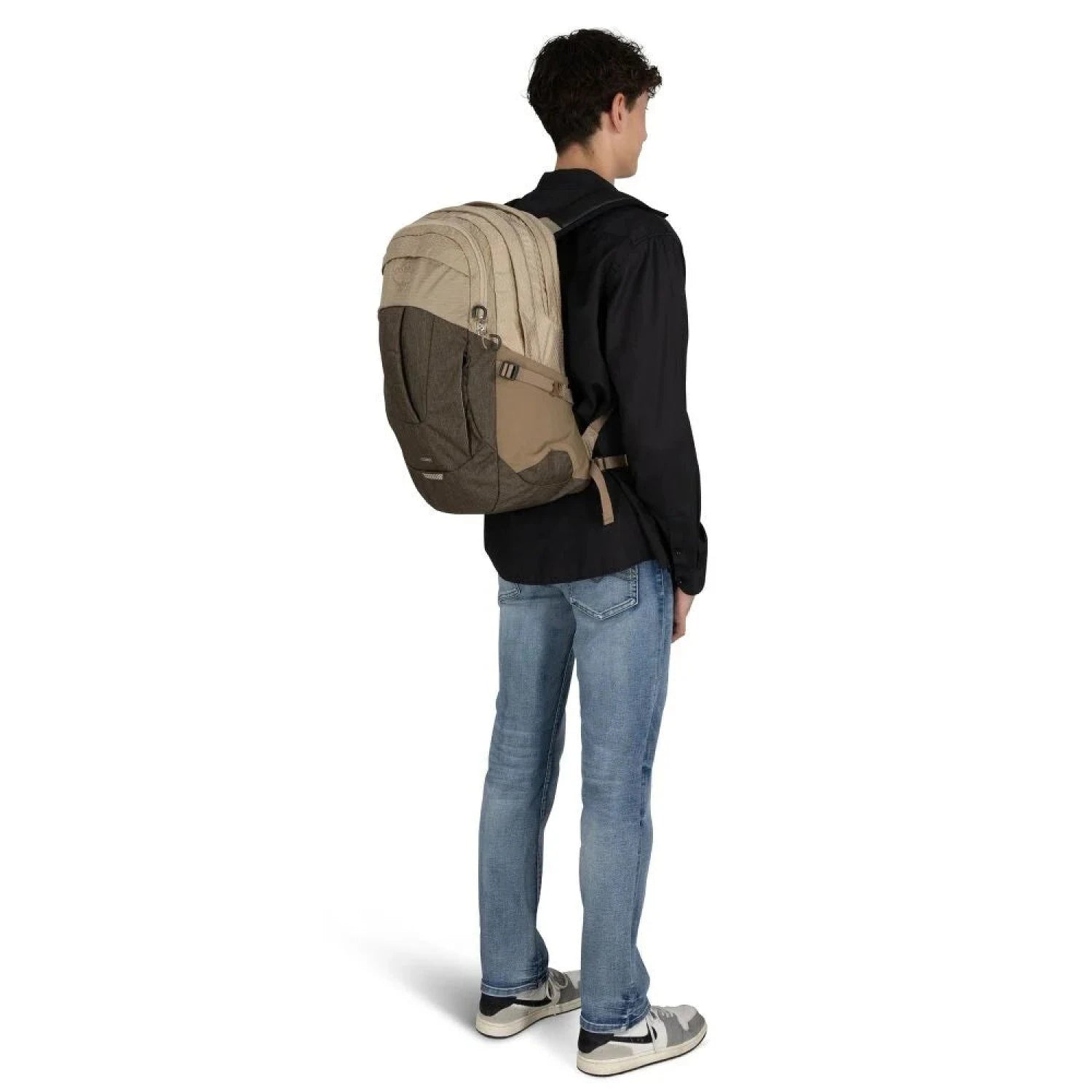 Osprey Comet 30 in Alpaca Tan Latte Brown, view of back of bag on model 