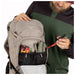 Osprey Raptor 14L Backpack with Reservoir in pediment grey, model showing front pocket detail
