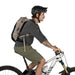 Osprey Raptor LT 12 Bike Hydration Pack in Pediment Grey Black, side view on model on bike