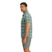 Outdoor Research Men's Astroman Short Sleeve Sun Shirt shown in the Balsam Plaid color option. Side view