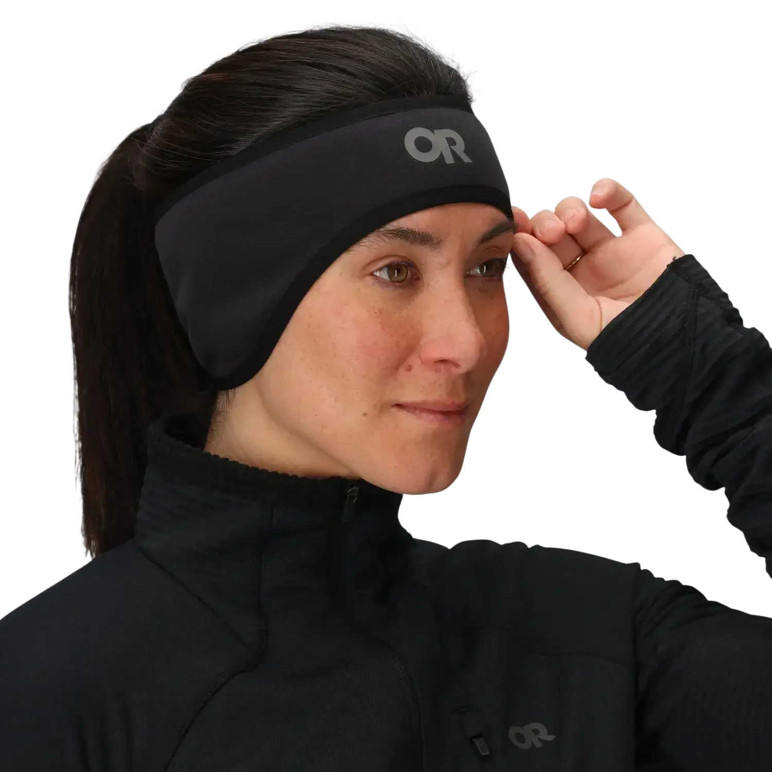 Person wearing a black headband with a brand logo on a plain background