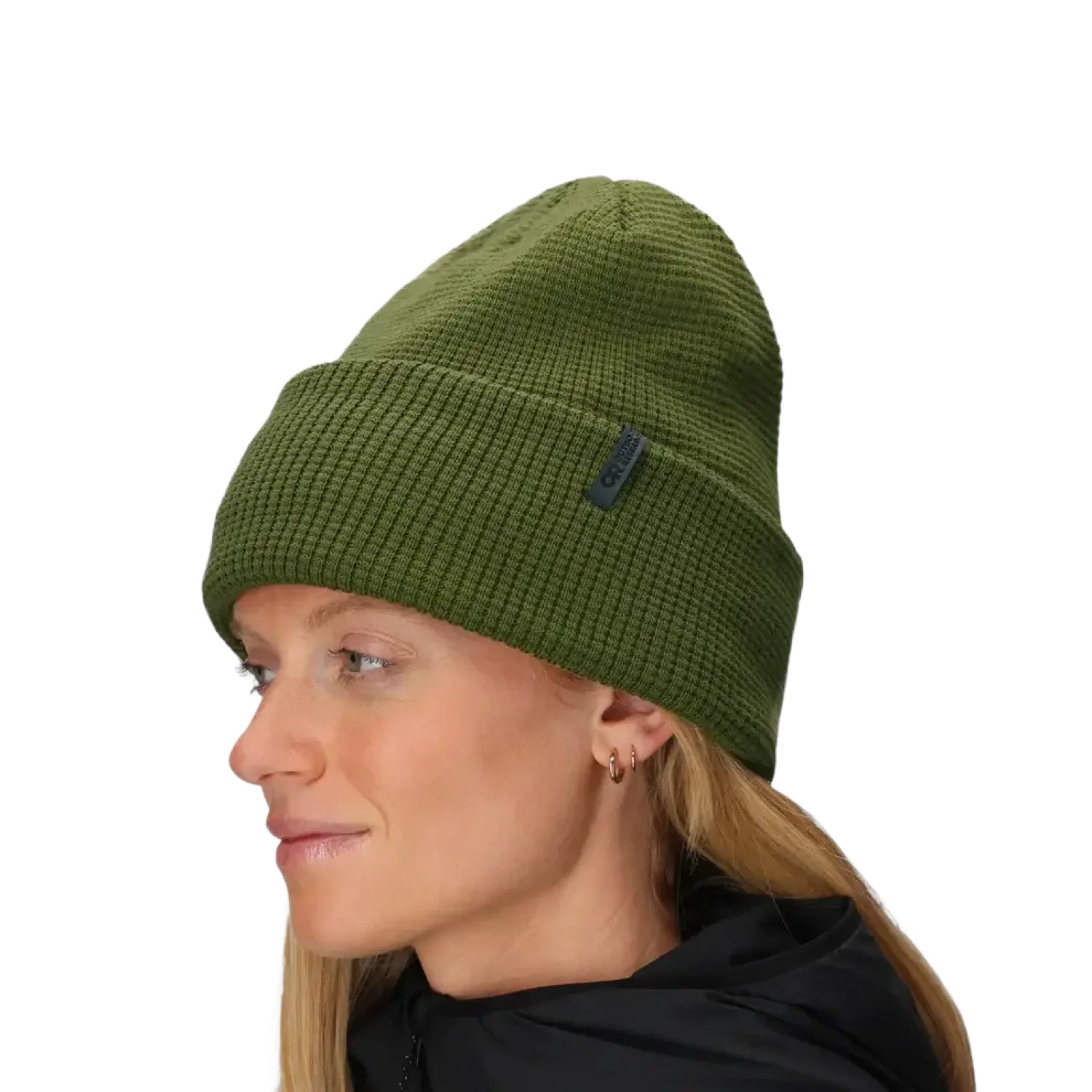 Person wearing a green knit beanie on a light gray background