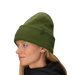Person wearing a green knit beanie on a light gray background