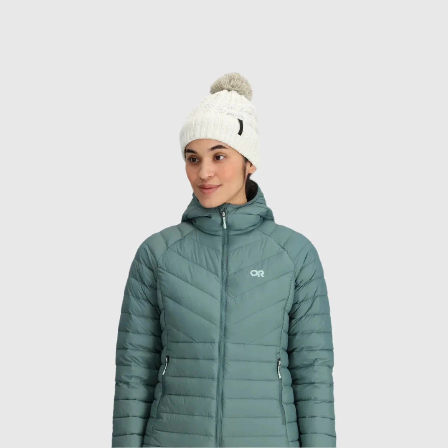 Outdoor Research Women's Liftie Beanie shown in the Bone color option.  Front view on model.