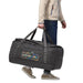 Patagonia Black Hole® Duffel Bag 100L shown in the Matte Unity Fitz: Ink Black color option carried by model , side view.