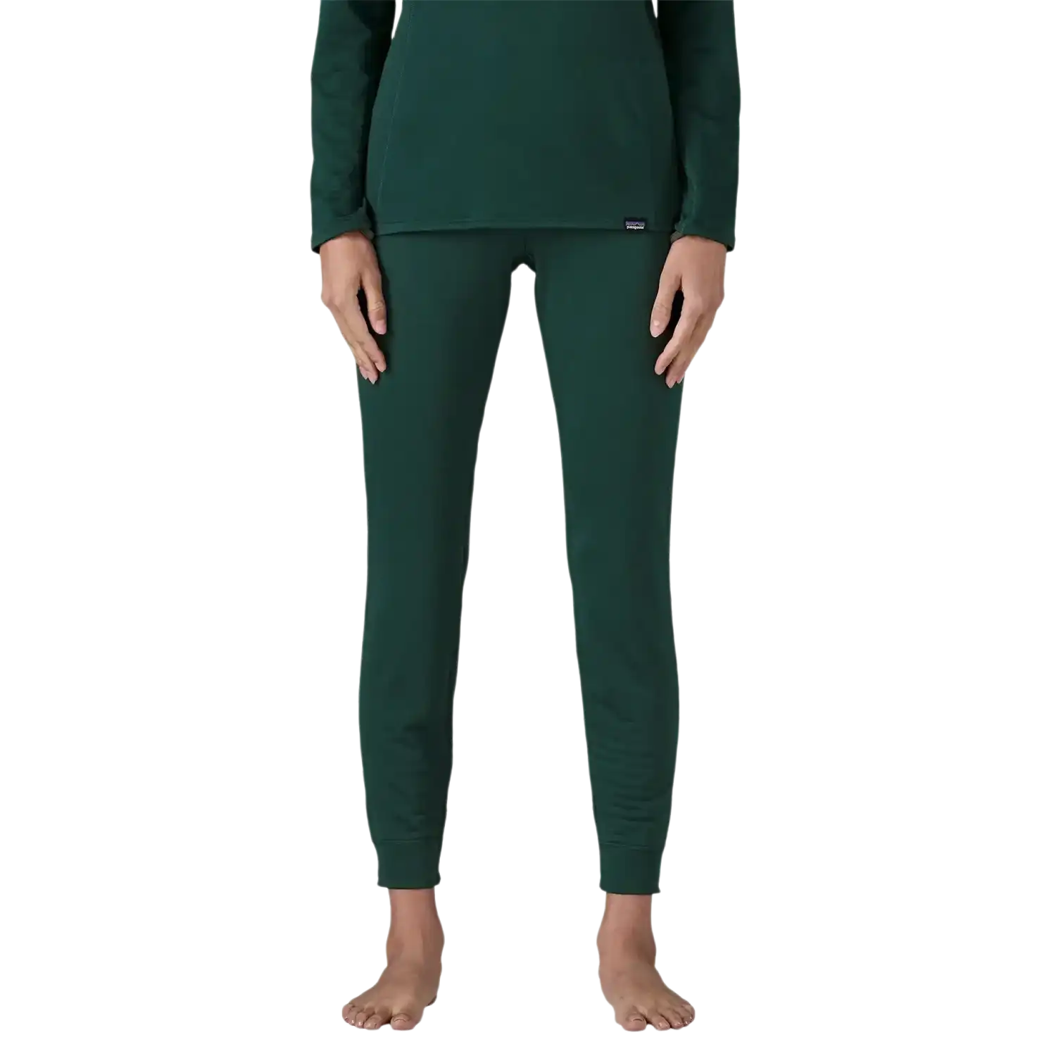 Patagonia Women's Capilene® Thermal Weight Bottoms in Cascade Green, front view on model