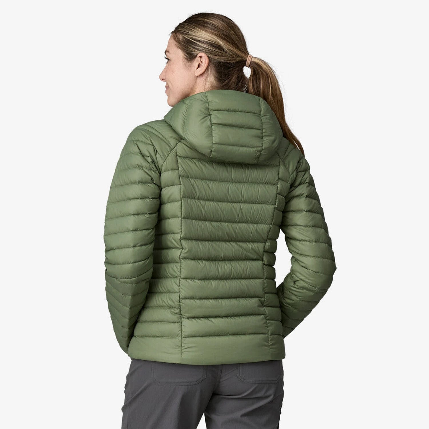 Patagonia Women's Down Sweater Hoodie shown in the Terrain Green color option. Back view on model.