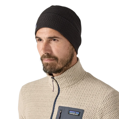 Model wearing a black Patagonia R1 Air Beanie 