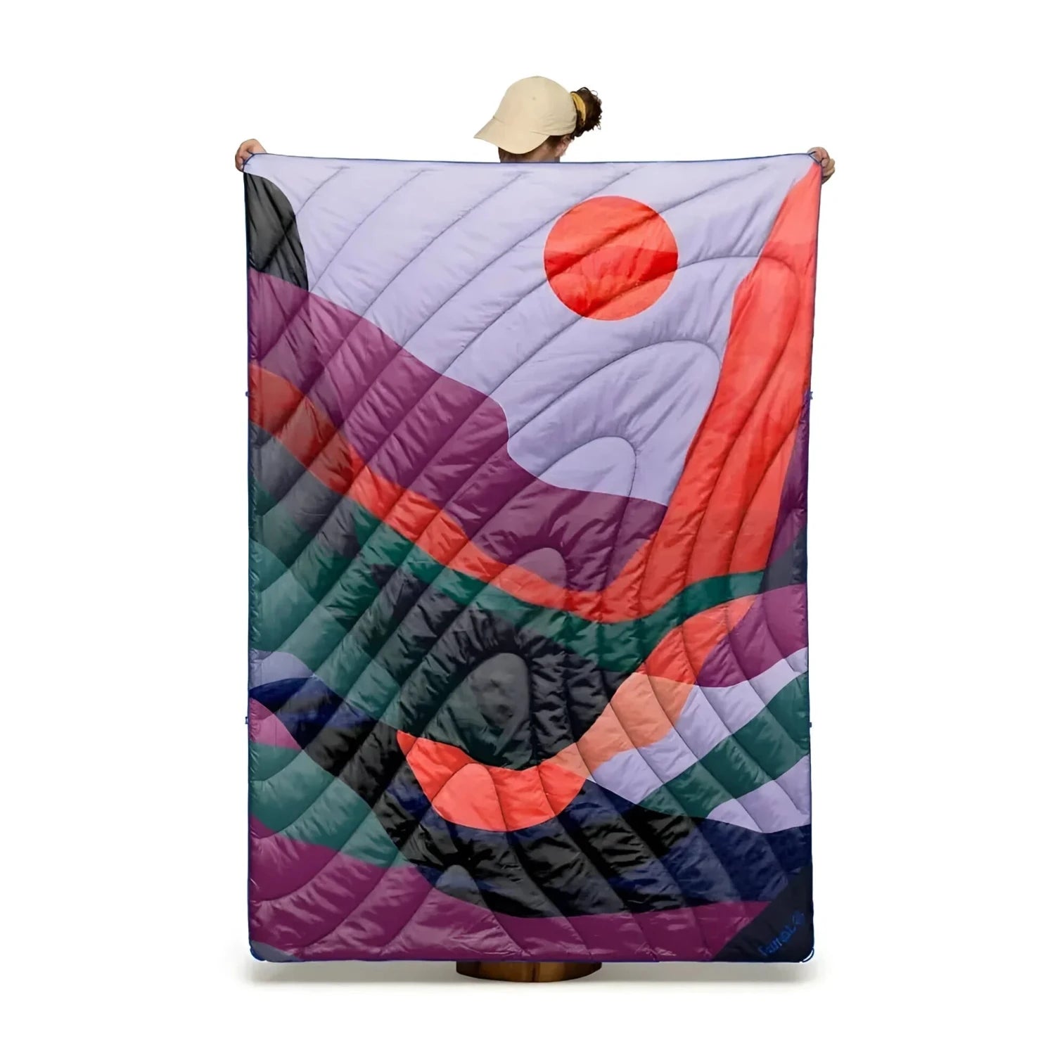 Rumpl Original Puffy Blanket in valley dusk, front view held up